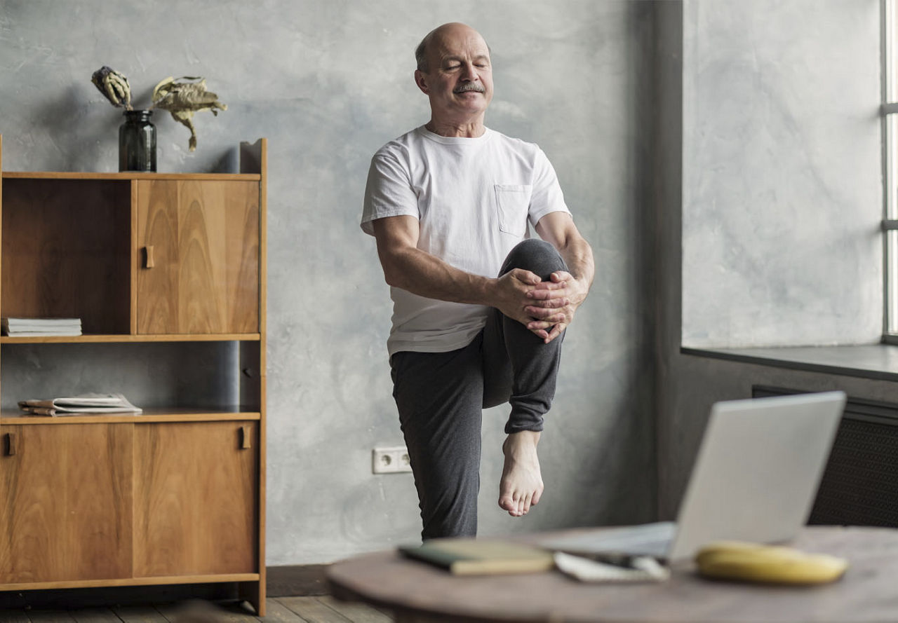 Old man stretching in room | Blog | Greystar